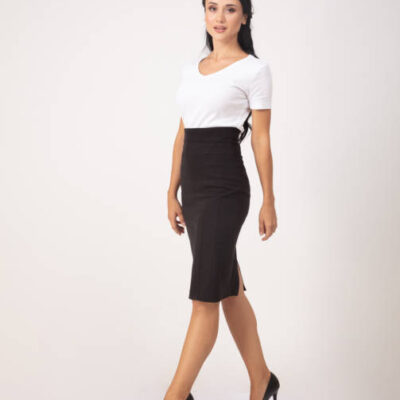 Classically dressed businesswoman in front of a white background.