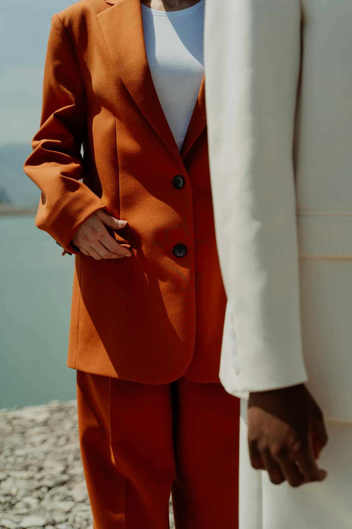 Fashionable suits showcased outdoors, emphasizing modern business style.